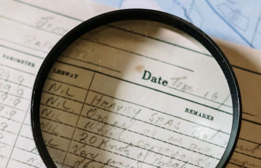A magnifying glass over a property records ledger